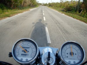 A motorcycle speeds past one of Blacktip Island’s intersections at rush hour Thursday.